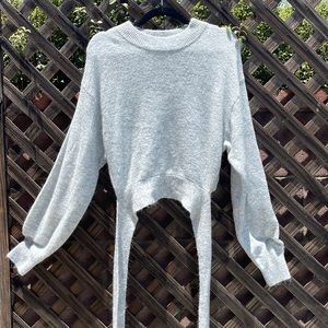 Grey H&M grey sweater with the bow tie in the back.